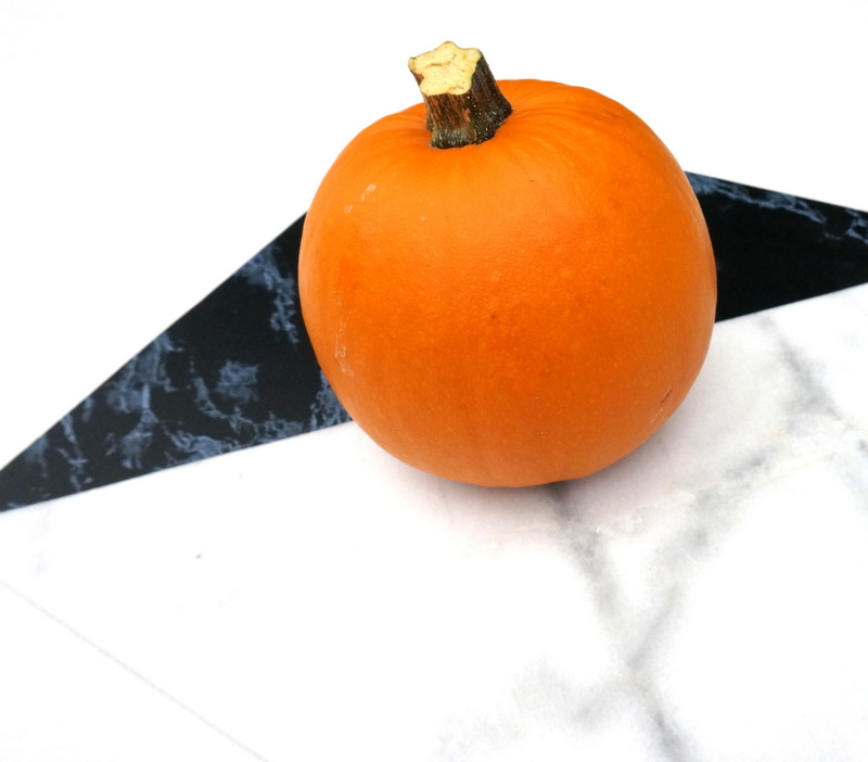 Classic orange pumpkin on a marble tile